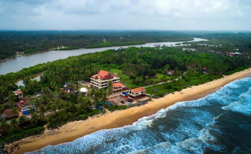 an aerial view of a resort on a beach at SHARVARI BEACH HOME STAY at Mangalore by Vaishnavi Reveries in Mangalore
