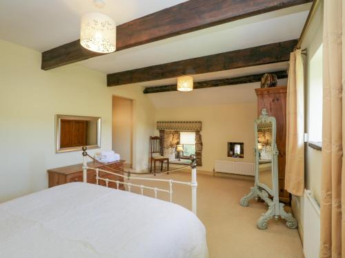 a bedroom with a white bed and a mirror at Dale View in Whitby