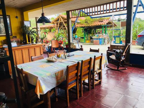 uma sala de jantar com uma mesa e algumas cadeiras em Castillo de Cascadas Finca Hotel em Salamina