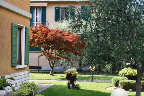 a house with a fire hydrant in the yard at Fontana Fiorita Iseo in Iseo