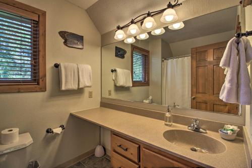 a bathroom with a sink and a large mirror at Alluring Nisswa Cabin on Gull Lake with Fireplace! in Nisswa