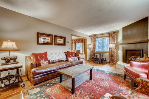 a living room with a leather couch and a table at Casa de Montagne Home: High-End Log Home, Downtown Frisco in Frisco