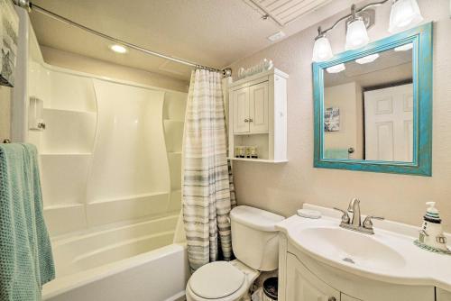 a bathroom with a sink and a toilet and a tub at Updated Front Beach Condo w/ Resort Amenities! in Corpus Christi