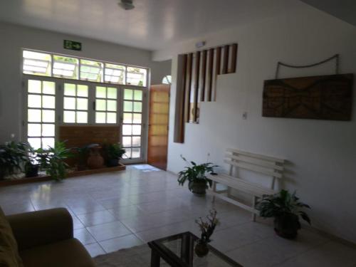 a living room with a couch and potted plants at Casa Hospedagem Diamantina in Diamantina