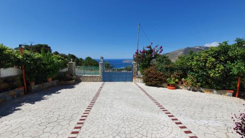 a cobblestone walkway in front of a house at Vila Riand in Borsh