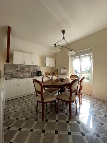 a kitchen with a dining room table and chairs at Le Grand Chalet in Bagnoles de l'Orne