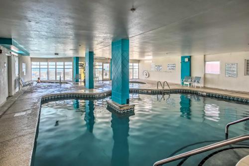 a swimming pool with blue columns in a building at Oceanfront North Myrtle Beach Gem Pools Access! in Myrtle Beach
