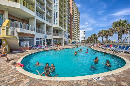 a pool at a resort with people in it at Oceanfront North Myrtle Beach Gem Pools Access! in Myrtle Beach