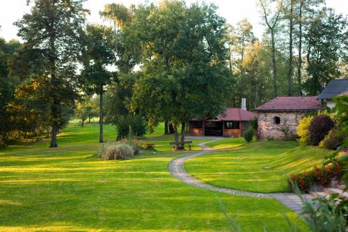 a garden with a stone house and a path at Cyprianówka in Warszowice