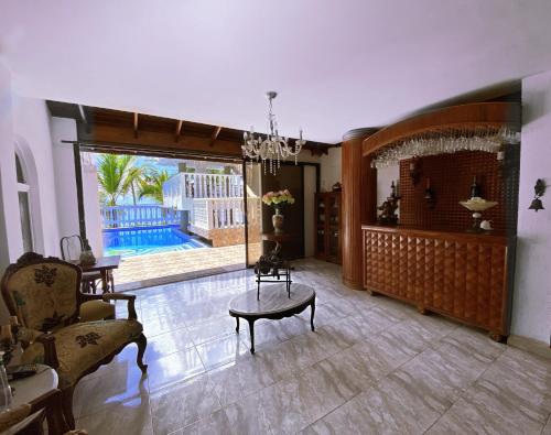 a living room with a chandelier and a table and a couch at Sunset Paradise in San Andrés