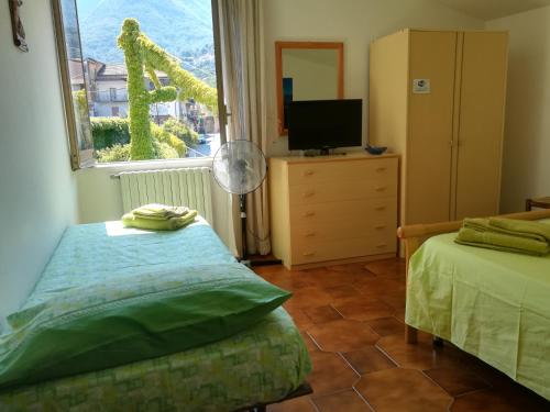 a bedroom with a bed and a window with a television at Casa Giordano Holidays in Tramonti