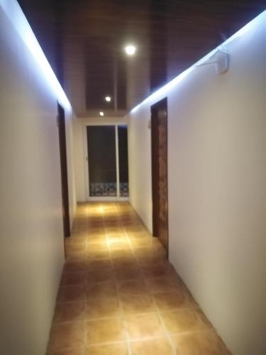 an empty hallway with lights on the wall at La Mansión del Faro in Tecolutla