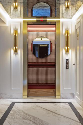 a room with a door with a television on it at The Alest Hotel in Mexico City