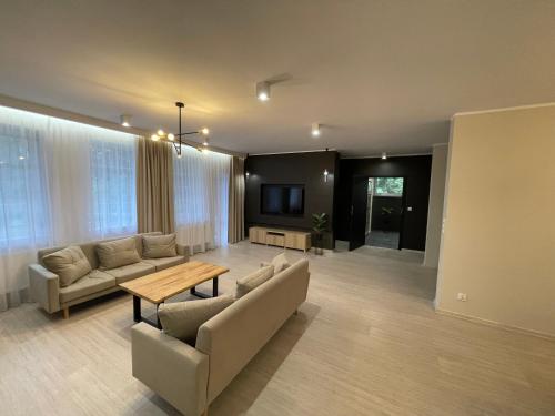 a living room with a couch and a table at Petrico Camp Resort in Krzywopłoty