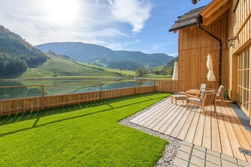 a patio with a table and chairs and a view of the mountains at CHALET am Schneeberg See in Puchberg am Schneeberg