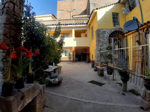 a courtyard of a house with plants and a fence at HOSPEDAJE CENTRAL in Ayacucho