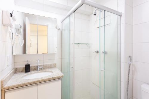 a bathroom with a sink and a shower at Beach Class Santa Maria by Easy Home in Recife