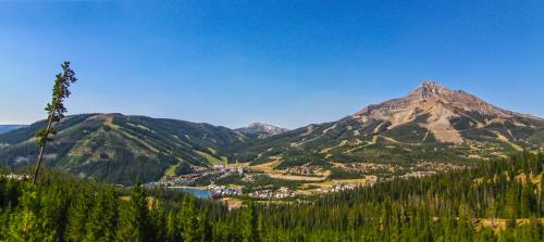 a valley with a town and a mountain at Huntley Lodge at Big Sky Resort in Big Sky