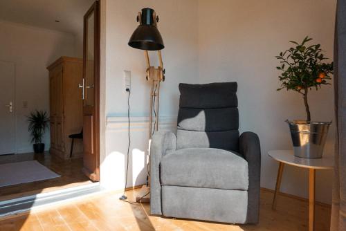 a living room with a chair and a lamp at Leutesdorfer Hof in Leutesdorf