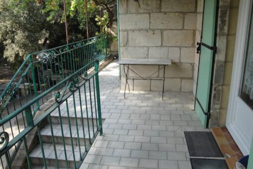 a bench sitting on a porch next to a door at Le mas de Lucien entre Arles, Nimes, Avignon. in Beaucaire