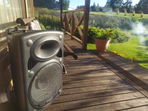 a speaker on a deck with a view of a garden at Mikalojiškis in Inturkė