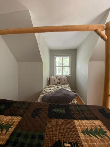 a bedroom with two beds in a attic at Eagle Mountain River Retreat in Ellijay