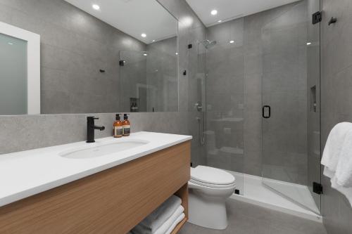 a bathroom with a sink and a shower and a toilet at Victorian Hotel in Vancouver