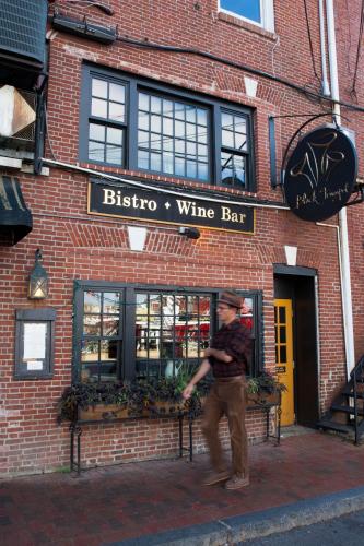 a man standing in front of a wine bar at The Bow Hotel in Portsmouth