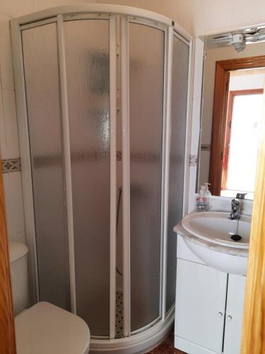 a bathroom with a shower and a sink at Casa de la Gloria in Baños de la Encina