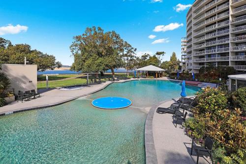 a large swimming pool with a frisbee in the water at Gemini Resort in Caloundra
