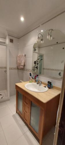 a bathroom with a sink and a mirror at Habitación privada al lado de la bahía de Santander in Santander