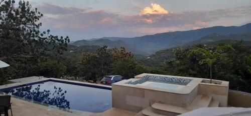 a swimming pool with a view of the mountains at Mountain View Anapoima in Anapoima