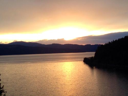 a sunset over a large body of water at Bennett Bay Inn in Coeur d'Alene