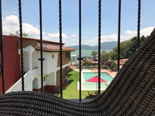 a view from a hammock in a resort with a pool at Hotel puesta del sol in Valle de Bravo