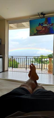 a man laying on the floor in a living room at Mountain View Anapoima in Anapoima