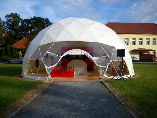 a white tent with a table in it at Hotel Floret in Pruhonice