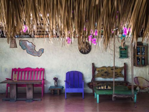 a room with two colorful chairs and a table at Una Posada Mas in Mazunte