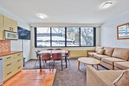 a living room with a couch and a table at Snow Ski Apartments 03 in Falls Creek