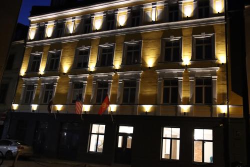 a building with lights on the side of it at Old Riga Plaza Hotel in Riga