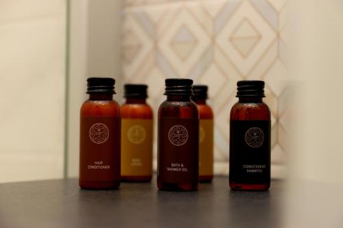 a group of four bottles of sauce on a table at Old Riga Plaza Hotel in Riga