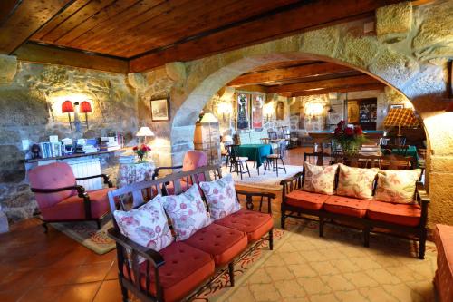 a living room with a bunch of chairs and tables at Casa da Lage in Ponte de Lima