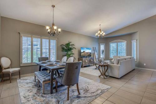 a dining room with a table and chairs and a couch at Casa De Arbol in El Paso