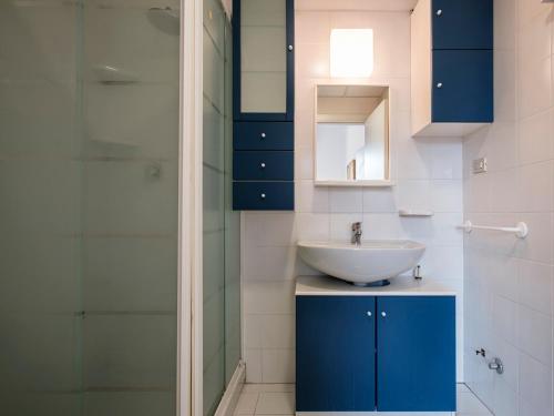 a bathroom with a sink and a glass shower at ResArt Iàcomus in Bologna
