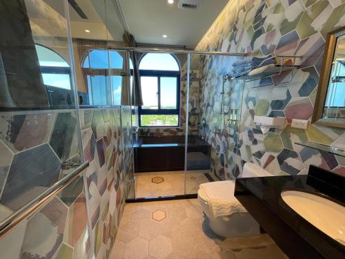a bathroom with a shower and a sink at Bohemia in Jian