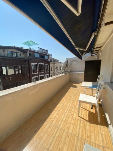 a balcony with a table and a bench on a roof at Blue Mosque Apart in Istanbul