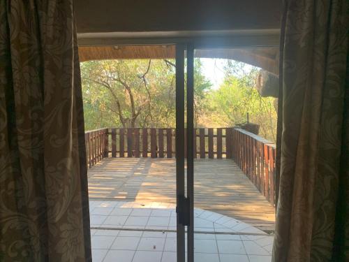 an open door to a porch with a deck at Selati River Ruins in Gravelotte
