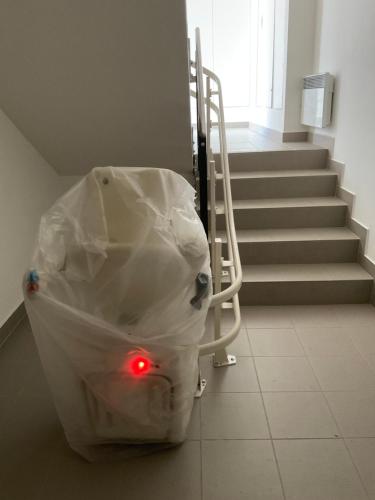 a plastic bag sitting on the floor next to a staircase at Útulný jednopokojový apartmán v alpském stylu na Klínovci in Loučná pod Klínovcem