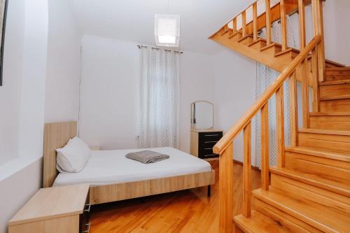a bedroom with a bed and a stair case at Laguna Villa - Pool, Sauna, Events - at Bazaleti Lake in Karsimaantkari