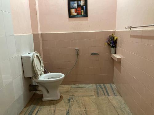 a bathroom with a toilet in a room at Haobam House in Imphal