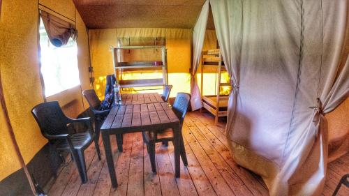 a dining room with a table and chairs in a room at Camping Prima in Týn nad Vltavou